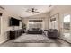 Cozy living room with a grey sofa, tv, and modern decor at 1289 E Baker Dr, San Tan Valley, AZ 85140