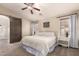 Relaxing main bedroom features a sliding barn door to the ensuite bath, ceiling fan, and natural light at 1289 E Baker Dr, San Tan Valley, AZ 85140