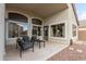 Covered outdoor patio with modern outdoor furniture and large windows providing plenty of light at 1289 E Baker Dr, San Tan Valley, AZ 85140