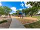 Neighborhood playground featuring play structures, benches, and a covered picnic area at 1289 E Baker Dr, San Tan Valley, AZ 85140