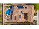 Aerial view of the tile roof with solar panels, blue pool, and courtyard of a luxury home at 13336 W Via Caballo Blanco --, Peoria, AZ 85383