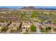Expansive aerial view showcasing the home with solar panels nestled in a lush, vibrant community near desert mountains at 13336 W Via Caballo Blanco --, Peoria, AZ 85383