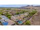 Aerial view of homes with pools, desert landscaping, and mountain views in a suburban neighborhood at 13336 W Via Caballo Blanco --, Peoria, AZ 85383
