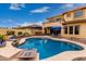 Backyard view of a two-story home featuring a pool, upstairs balcony, and desert landscaping at 13336 W Via Caballo Blanco --, Peoria, AZ 85383