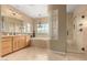 Luxurious bathroom featuring a double vanity, soaking tub, glass block feature, and a separate shower at 13336 W Via Caballo Blanco --, Peoria, AZ 85383