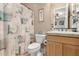 Cozy half bathroom featuring a decorated shower curtain, single sink vanity, and a standard toilet at 13336 W Via Caballo Blanco --, Peoria, AZ 85383