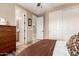 Bedroom with wood-look flooring, closet doors, ensuite bathroom and comfortable furnishings at 13336 W Via Caballo Blanco --, Peoria, AZ 85383