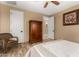 Bedroom with wood-look flooring, accent chair, closet, dresser and neutral walls at 13336 W Via Caballo Blanco --, Peoria, AZ 85383