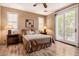 Bedroom with wood-look floors, large window, glass patio doors, and a comfortable queen sized bed at 13336 W Via Caballo Blanco --, Peoria, AZ 85383
