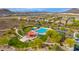 Aerial view showcasing the community pool area, with a playground, landscaping, and plenty of parking at 13336 W Via Caballo Blanco --, Peoria, AZ 85383