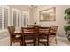 Elegant dining room featuring a wooden table, comfortable chairs, and plantation shutters at 13336 W Via Caballo Blanco --, Peoria, AZ 85383
