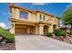 Two-story home with a porte-cochère, arched entry, tile roof, desert landscaping, and a spacious driveway at 13336 W Via Caballo Blanco --, Peoria, AZ 85383