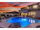 Exterior view of a two-story home featuring a pristine pool, an upstairs balcony, and desert landscaping at 13336 W Via Caballo Blanco --, Peoria, AZ 85383