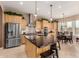 Spacious kitchen with a large granite island, stainless appliances, and custom cabinetry at 13336 W Via Caballo Blanco --, Peoria, AZ 85383