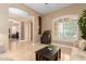 Comfortable living room featuring neutral-toned walls, tile flooring, and large window shutters at 13336 W Via Caballo Blanco --, Peoria, AZ 85383