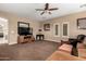 Spacious living room featuring neutral tones, entertainment center, and windows with natural light at 13336 W Via Caballo Blanco --, Peoria, AZ 85383