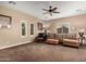 Inviting living room with a cozy sofa, decorative pillows, and natural light from multiple windows at 13336 W Via Caballo Blanco --, Peoria, AZ 85383
