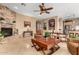 Open living area with stone fireplace, comfortable seating, and views into the kitchen at 13336 W Via Caballo Blanco --, Peoria, AZ 85383