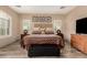 Cozy main bedroom with a decorative headboard and wood floors at 13336 W Via Caballo Blanco --, Peoria, AZ 85383