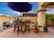 View of an outdoor kitchen featuring a grill, bar, and seating under the shade of an outdoor structure at 13336 W Via Caballo Blanco --, Peoria, AZ 85383