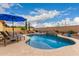 Inviting pool featuring lounge chairs, desert landscaping, and a clear blue sky at 13336 W Via Caballo Blanco --, Peoria, AZ 85383