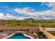 Tranquil view of a sparkling pool surrounded by lush desert landscaping, creating a serene backyard oasis at 13336 W Via Caballo Blanco --, Peoria, AZ 85383