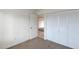 Cozy bedroom with closet space, neutral carpeting, and a view of adjoining spaces, creating a comfortable area at 1410 W Morrow Dr, Phoenix, AZ 85027