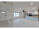 Spacious living area with light tile flooring, abundant natural light, and an open floor plan to the kitchen at 1410 W Morrow Dr, Phoenix, AZ 85027