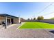 Backyard with artificial turf, gravel, and covered patio area with seating for relaxing outdoors at 14842 N 36Th St, Phoenix, AZ 85032
