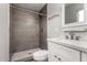 Bathroom featuring a tiled walk-in shower, a modern white vanity with quartz countertop, and contemporary fixtures at 14842 N 36Th St, Phoenix, AZ 85032