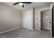 Bedroom featuring gray carpet, brick veneer walls, and standard closet, complemented by neutral tones at 14842 N 36Th St, Phoenix, AZ 85032