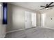 Spacious bedroom with plush carpet, ceiling fan, and a neutral color scheme at 14842 N 36Th St, Phoenix, AZ 85032