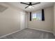 Bedroom showcasing gray carpet, brick veneer walls, a window, and standard closet with neutral tones at 14842 N 36Th St, Phoenix, AZ 85032