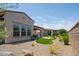 Spacious backyard featuring turf, gravel, and drought-tolerant shrubs and greenery at 156 E Leverenz Ave, Queen Creek, AZ 85140