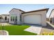 Backyard featuring a covered patio, artificial turf and gravel landscaping at 156 E Leverenz Ave, Queen Creek, AZ 85140