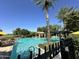 Resort-style community pool with palm trees and clear blue water on a sunny day at 156 E Leverenz Ave, Queen Creek, AZ 85140