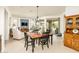 Cozy dining area with a table and chairs, seamlessly connected to the living room and outdoor patio at 156 E Leverenz Ave, Queen Creek, AZ 85140