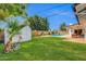 Lush backyard featuring a refreshing pool, green grass, and a storage shed at 1643 W Harmont Dr, Phoenix, AZ 85021