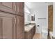Bathroom featuring granite counters and a large cabinet for storage at 1643 W Harmont Dr, Phoenix, AZ 85021