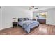 Comfortable bedroom with hardwood floors, ceiling fan and a window at 1643 W Harmont Dr, Phoenix, AZ 85021