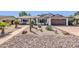 Charming single-story home with desert landscaping, rocks and cacti at 1643 W Harmont Dr, Phoenix, AZ 85021