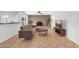 Bright living room with brick fireplace, tiled floors, and access to the backyard at 1643 W Harmont Dr, Phoenix, AZ 85021