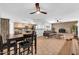 Open-concept living room with modern kitchen, dining area, fireplace, and tile flooring at 1643 W Harmont Dr, Phoenix, AZ 85021