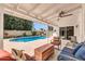 A covered patio beside a sparkling pool, great for relaxing and outdoor living at 1643 W Harmont Dr, Phoenix, AZ 85021