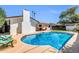 Backyard featuring a sparkling pool, an updated exterior and patio at 1643 W Harmont Dr, Phoenix, AZ 85021