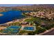 Aerial view showcasing community amenities including tennis courts, basketball court, lake, and picnic areas at 17985 W Jojoba Rd, Goodyear, AZ 85338
