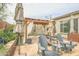 Inviting backyard with pergola, outdoor seating, shade umbrellas, and meticulously manicured landscaping at 17985 W Jojoba Rd, Goodyear, AZ 85338