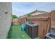 Backyard with artificial turf, storage, and functional design elements, creating an organized outdoor space at 17985 W Jojoba Rd, Goodyear, AZ 85338
