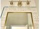 Bathroom mirror with decorative light fixture and decorative tile backsplash at 17985 W Jojoba Rd, Goodyear, AZ 85338