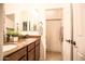 Bright bathroom featuring double sinks and a separate toilet and shower area at 17985 W Jojoba Rd, Goodyear, AZ 85338